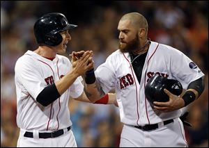 Boston Red Sox's Stephen Drew, left, and Jonny Gomes celebrate after they scored on a single by Will Middlebrooks in the fifth inning of a baseball game against the Detroit Tigers at Fenway Park in Boston, Tuesday, Sept. 3, 2013. (AP Photo/Elise Amendola)