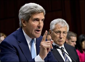 Defense Secretary Chuck Hagel listens at right as Secretary of State John Kerry testifies on Capitol Hill in Washington before the Senate Foreign Relations Committee hearing to advance President Obama's request for congressional authorization for military intervention in Syria.
