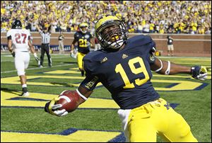 Michigan's Devin Funchess scored five touchdowns last season. The move to a pro style offense this season makes the 6-foot-5 tight end more of an offensive option for the Wolverines.