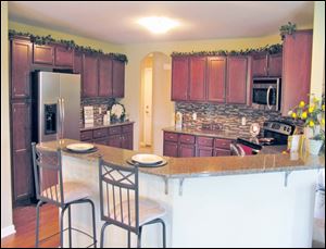 This kitchen’s fabulous granite countertop extends to the long snack bar.  