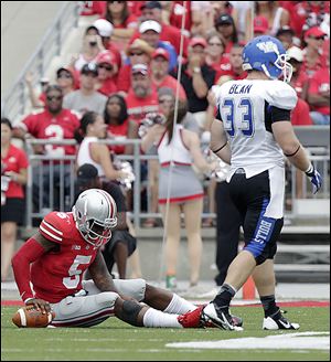 Braxton Miller, left, fights a leg cramp against Buffalo last week. Ohio State quarterbacks took six sacks during a season-opening victory last week. Only six of 120 FBS teams allowed more.