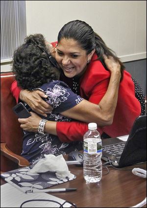 Volunteer Maggie Martinez gets a hug from county Auditor Anita Lopez at Teamsters hall. Ms. Lopez said her campaign is ‘moving in the right direction.’