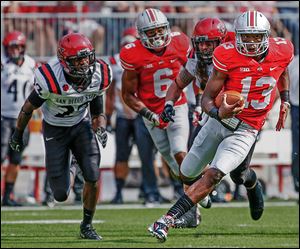 Ohio State quarterback Kenny Guiton breaks loose for a big gain against San Diego State. The senior rushed for 82 yards.