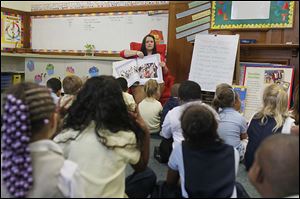 Sherri Grup reads to her kindergarten class at the new Discovery Academy, a charter school on the Notre Dame Academy campus. 