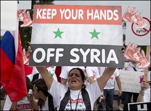 Protesters against U.S. military action in Syria shout during a demonstration in front of the White House in Washington, Monday, Sept. 9, 2013. On Tuesday, President Barack Obama will address the nation regarding Syria.  (AP Photo/Carolyn Kaster)
