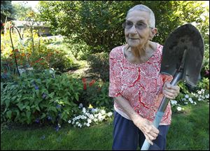 95-year-old Marie F. McCarty poses near the garden.