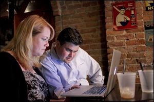 Mayoral candidate Joe McNamara watches along with his wife, Valerie Moffitt, as results come in September 10, 2013 during McNamara's election party at The Attic in downtown Toledo. 