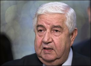Syrian Foreign Minister Walid al-Moallem speaks to the media in Moscow, Monday. Syria's foreign minister said his country welcomes Russia's proposal for it to place its chemical weapons under international control and then dismantle them quickly to avert U.S. strikes. 