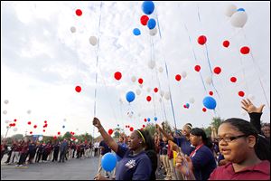  Senior Toni Payton, right, joins schoolmates in re-leasing a balloon during a “We Have Not Forgotten” tribute at Horizon Science Academy Toledo.