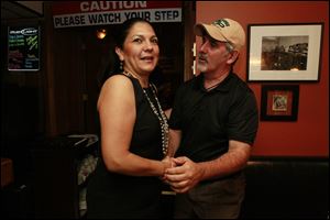 Anita Lopez shakes hands with Councilman Steven C. Steel on election night at Michael's Bar & Grill. Lopez did not show up until around midnight.