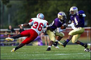 Bowsher junior Phoenix Reid tackles Maumee's Brian Autry. Reid is third on the team with 11 tackles.