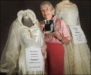 Etta Hoot shows the wedding dress and veil she bought at Tiedtke’s for $39. It will be among the items on display Friday and Saturday.