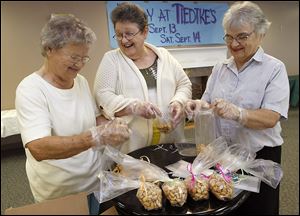Evelyn Crossen, Sally Snell and Sally Shaw bag cashews for Tiedtke's Days at the Margaret Hunt Senior Center. Fresh cashews were just one of numerous Tiedtke’s mainstays.
