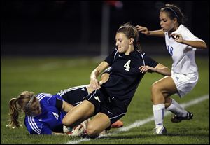 Anthony Wayne goalkeeper Taylor Hill stops the ball as Perrysburg's Lucy Walton, center, and the Generals' Baily Hertzfeld move in.