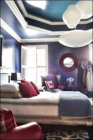 Several vintage George Nelson bubble pendants are grouped together to hang above this bed, creating a warm pool of light in the bedroom. The vintage pendants, made of wire and vinyl, add a playful touch to any space. 