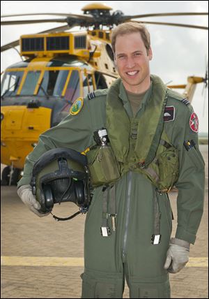 Britain's Prince William poses in front of a Sea King helicopter  at RAF Valley in Anglesey Wales in 2012.