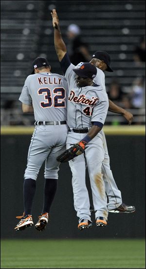 Detroit Tigers outfielders Don Kelly (32), Austin Jackson, and Torii Hunter (48) celebrate after defeating the Chicago White Sox 1-0.
