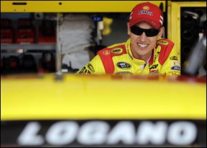 Driver Joey Logano looks from his garage during practice for the NASCAR Sprint Cup Series auto race at Chicagoland Speedway in Joliet, Ill., Friday, Sept. 13, 2013.