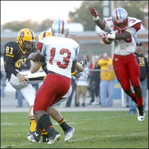 Bowsher's Phoenix Reed blocks Northview's Raymond Martinek punt in the second quarter. Reed picked up the ball and scored a touchdown.
