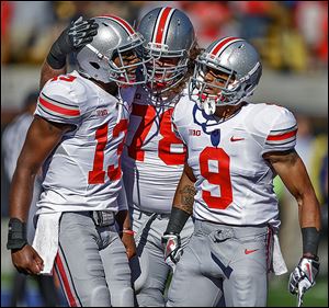 Ohio State's Kenny Guiton, left, Andrew Norwell, and Devin Smith celebrate Smith's touchdown against California.