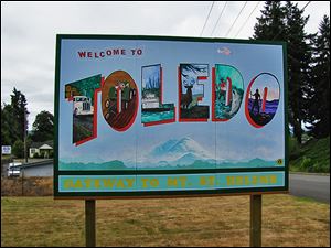 A billboard in Toledo, Wash., welcomes visitors. Rich in history, recreation, and volunteerism, it has about 725 residents.