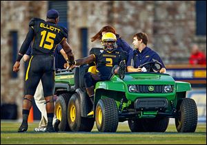 University of Toledo player Jayrone Elliott (15) speaks to quarterback Terrance Owens (2) as Owens is taken from the field with an injury Saturday at the Glass Bowl.