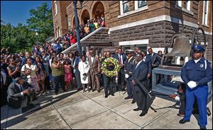 Churchgoers gather outside as a wreath is placed at 16th Street Baptist Church in Birmingham, Ala., on the 50th anniversary of the bombing that killed four young girls and galvanized the civil rights movement. Hundreds attended Sunday’s commemoration event and said the work to ensure racial equality is unfinished.
