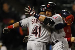 Cleveland's Asdrubal Cabrera, right, celebrates with teammate Carlos Santana after hitting a home run against the Chicago White Sox during the sixth inning today in Chicago. Santana also scored on Cabrera's home run.