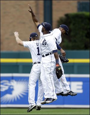 Detroit Tigers outfielders Andy Dirks, left, Torii Hunter, and Austin Jackson celebrate their 3-2 win over the Kansas City Royals todayin Detroit.