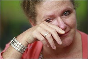 Karen Jones, the best friend of the slain Sharon Ward, wipes away tears as she talks about the case on September 12, 2013.