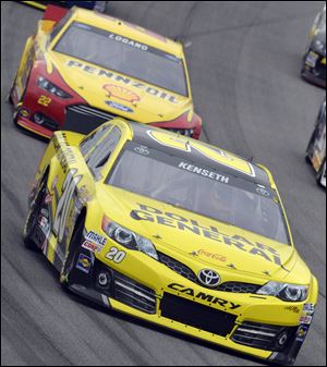 Matt Kenseth drives past Joey Logano during Sunday night's NASCAR Sprint Cup series race at Chicagoland Speedway in Joliet, Ill. Kenseth won.