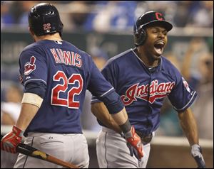 Cleveland Indians' Michael Bourn, right, is congratulated by Jason Kipnis (22) on his solo home run off Kansas City Royals relief pitcher Luke Hochevar during the ninth inning.