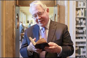 David Redden, vice chairman of Sotheby's, looks over the Bay Psalm Book. The legendary auctioneer, who has sold everything from the jewels of the late Duchess of Windsor, to the piano from the Bogart-Bergman classic ‘Casablanca.’