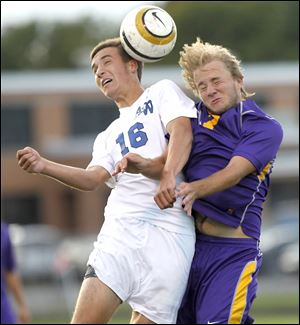 Anthony Wayne’s AJ Witte, left, and Maumee's KJ Mitchell fight to head the ball.