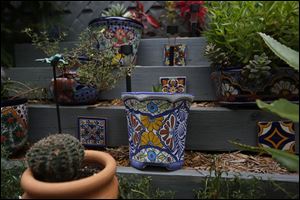 His patio includes Mexican tiles and growing containers, called Talavera Pots, stacked on tiers. 