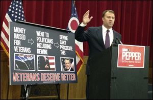 Democrat David Pepper speaks to reporters at a news conference Friday  in Columbus. Mr. Pepper wants Mike DeWine to recuse himself from the case against a Florida man accused of running a scam charity.