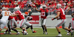 Ohio State quarterback Kenny Guiton (13) throws the ball against  Florida A&M during the second quarter. Guiton threw a school record 6 TDS, all in the first half. 