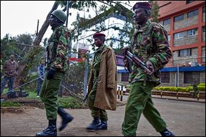 Kenyan security personnel take their positions outside the Westgate Mall. Gunfire and explosions were heard during the fighting at the upscale shopping center.