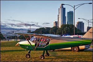 A plane is parked near Lake Shore Drive in Chicago on Sunday after the pilot, John Pedersen, made an emergency landing because of mechanical issues. He landed in the northbound lanes of Lake Shore Drive near Grant Park, authorities said. 