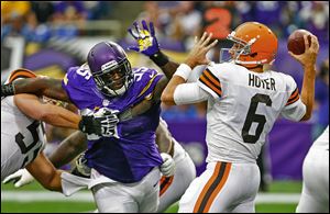 Browns quarterback Brian Hoyer (30 of 54 for 321 yards) passes the ball while getting pressured by Minnesota defensive tackle Sharrif Floyd.