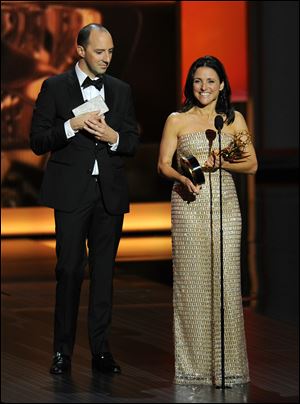 Tony Hale watches as Julia Louis-Dreyfus accepts the award for outstanding lead actress in a comedy series for her role on Veep at the 65th Primetime Emmy Awards at Nokia Theatre on Sunday  in Los Angeles.