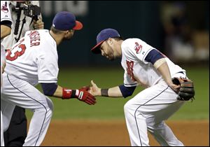 Indians' Nick Swisher, left, and Jason Kipnis celebrate after a 4-1 win over the Houston Astros on Saturday night in Cleveland.
