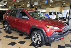 A 2014 Jeep Cherokee Trailhawk is on display at Charlie’s Dodge in Maumee. Chrysler has temporarily slowed production of the new model for testing. 