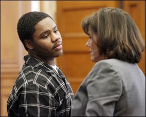 Traquawn Gibson, 19, confers with his attorney, Meira Zucker, as his jury trial begins for two deaths: the Oct. 18 murder of Deontae Allen of Toledo and the Nov. 18 aggravated murder of his longtime girlfriend, CreJonnia ‘C.J.’ Bell, also of Toledo.
