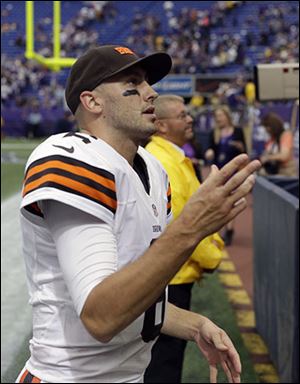 Browns quarterback Brian Hoyer tosses a wrist band to fans after Cleveland beat the Vikings on Sunday. It was his first win as a starter in the NFL.