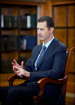 Syrian President Bashar Assad speaks during an interview with Chinese state CCTV, in Damascus, Syria, today. Assad said his government will allow international experts access to its chemical weapons sites but cautioned that rebels might block them from reaching some of the locations.