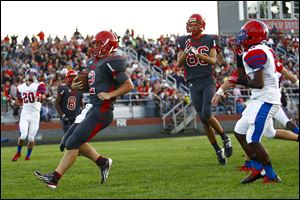 Bedford quarterback Brad Boss scores against St. Francis as Trent Santiago (86) celebrates. Boss has rushed for 349 yards on 35 carries.
