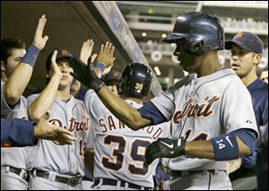 Detroit Tigers' Austin Jackson, right, is greeted in the dugout after his two-run home run off Minnesota Twins pitcher Scott Diamond in the fourth inning.