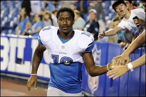 Detroit Lions wide receiver Nate Burleson (13) walks away from fans after signing autographs last month.