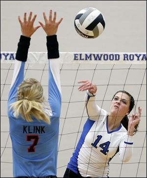 Elmwood's Jasmine Marsh, right, spikes the ball against  Eastwood's Sarah Klink during Tuesday’s match. Marsh finsihed with 16 kills.